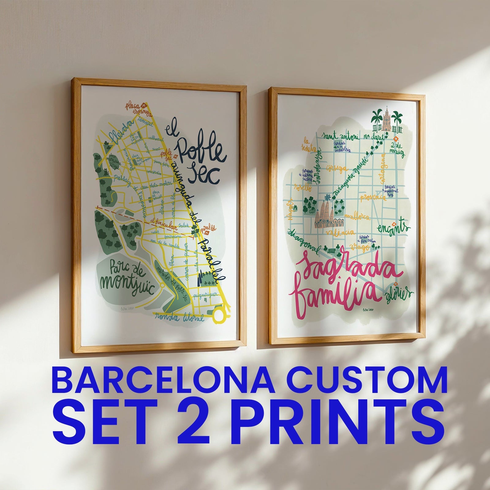 Two framed maps of Barcelona with decorative text on a wall.