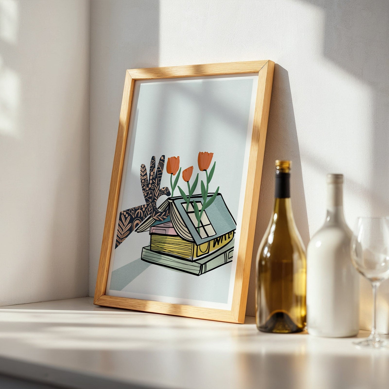 Framed artwork on a shelf with bottles and glasses in the background