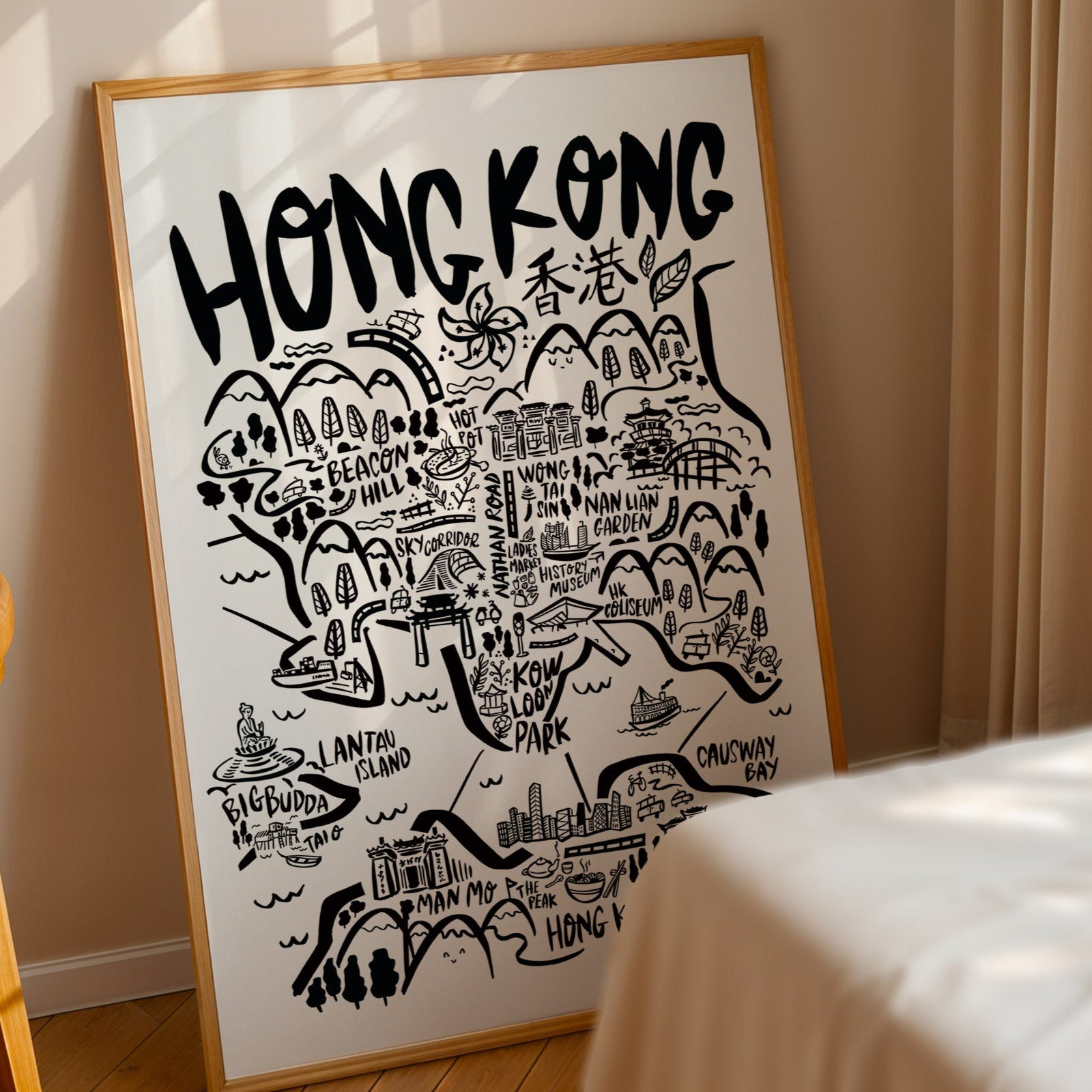 Framed map of Hong Kong with decorative elements on a wall.