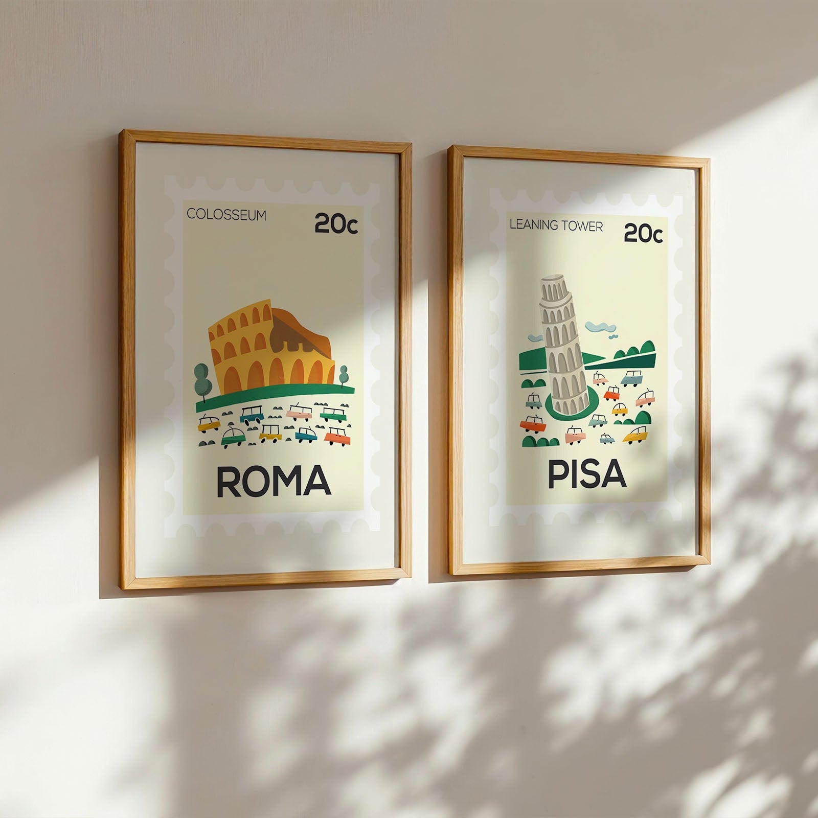 Two framed illustrations of the Colosseum and Leaning Tower of Pisa on a wall.