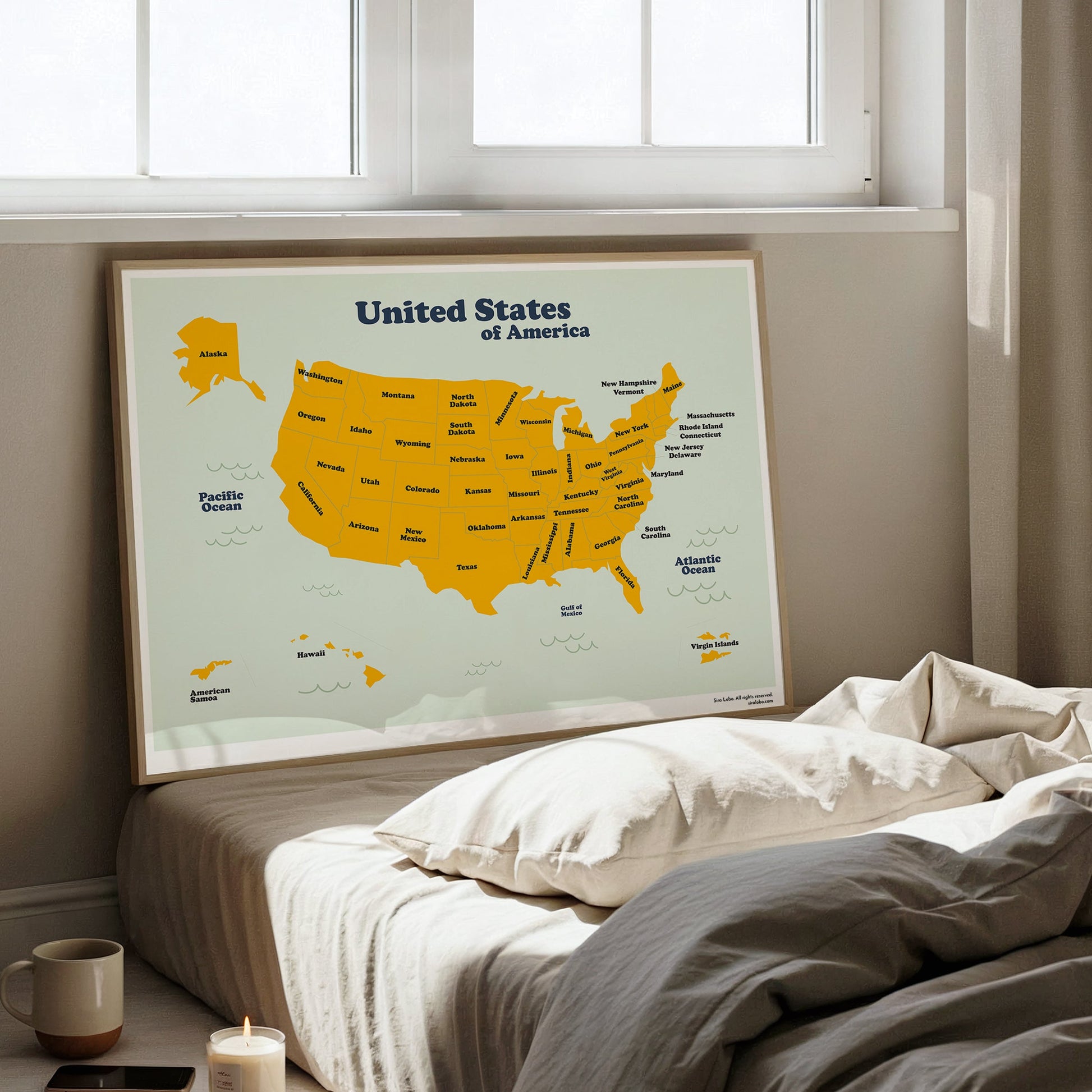 Map of the United States on a wall above a bed in a bright room