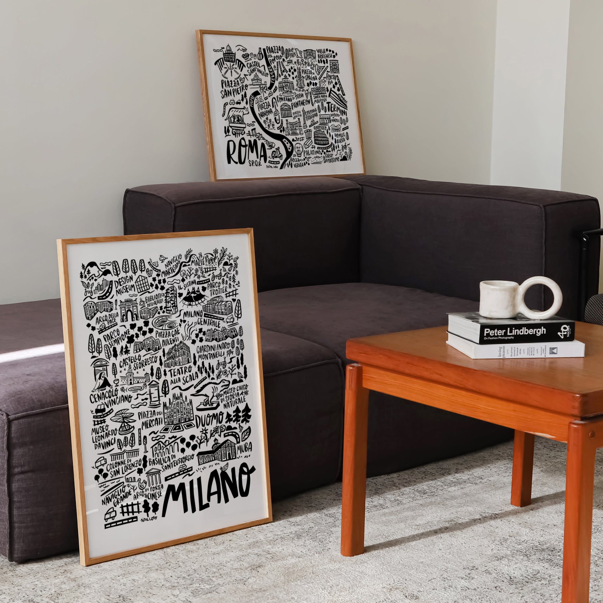 Living room with a brown sofa, wooden coffee table, and framed artwork on the wall.