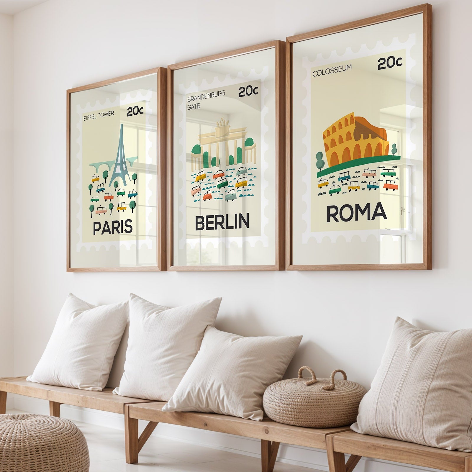 Three framed prints of famous landmarks in Paris, Berlin, and Rome above a wooden bench with cushions.