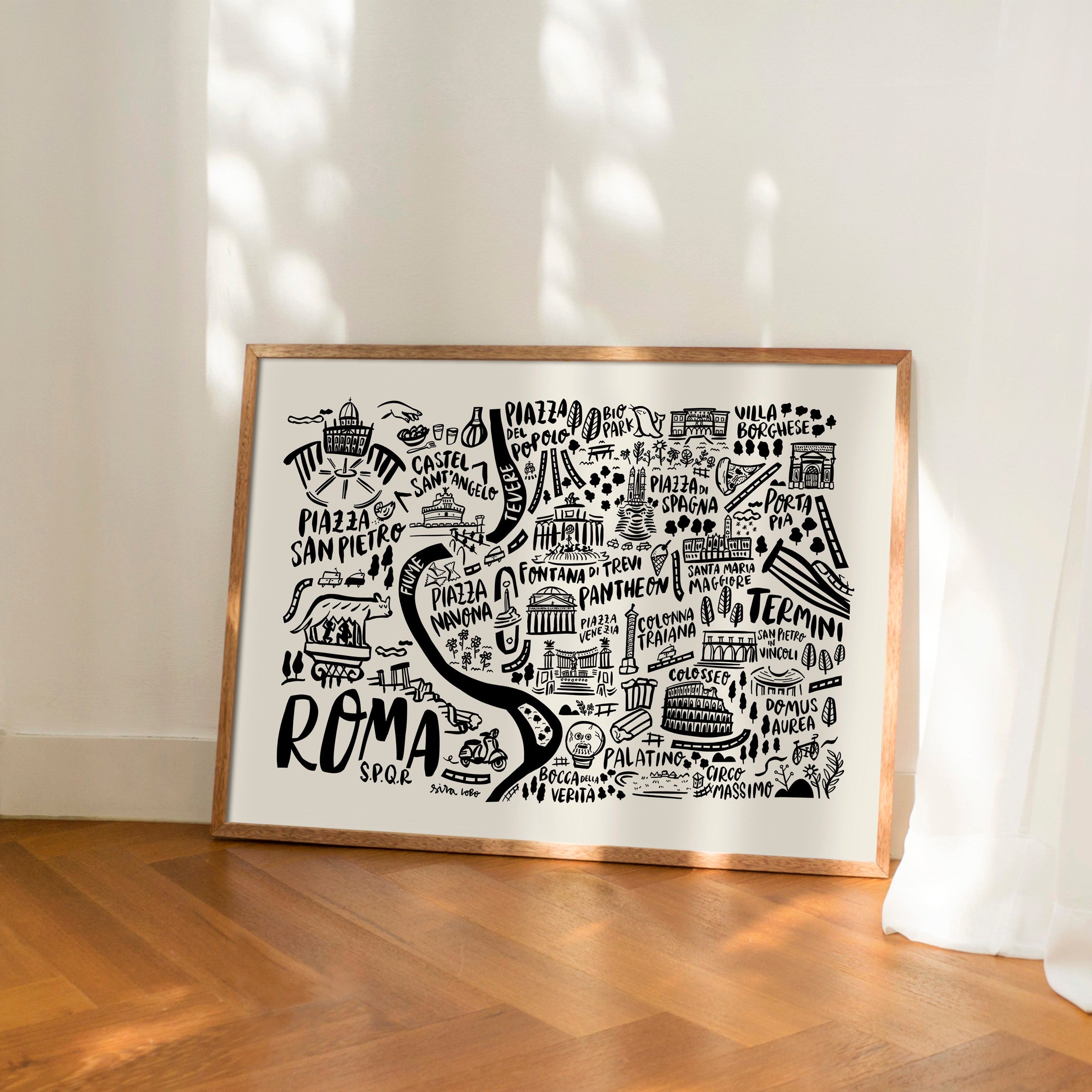 Framed artwork with 'Roma' design on a wooden floor