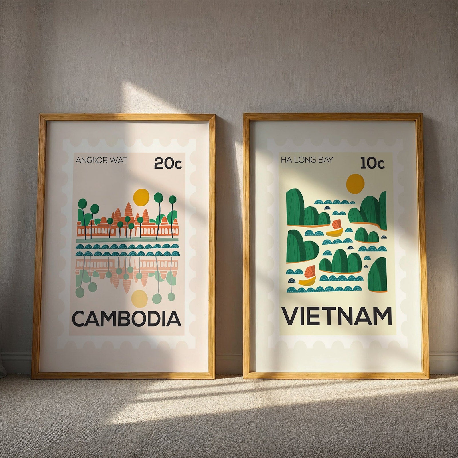 Two framed illustrations of Cambodia and Vietnam on a wall.