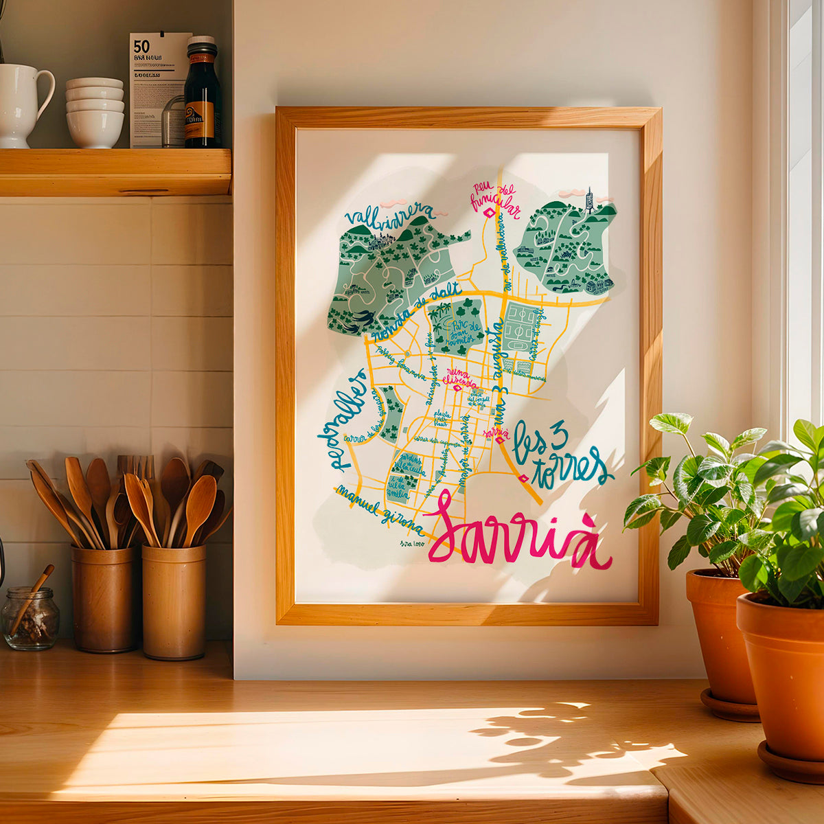 Framed map of Sarrià in Barcelona on a wall in a kitchen setting
