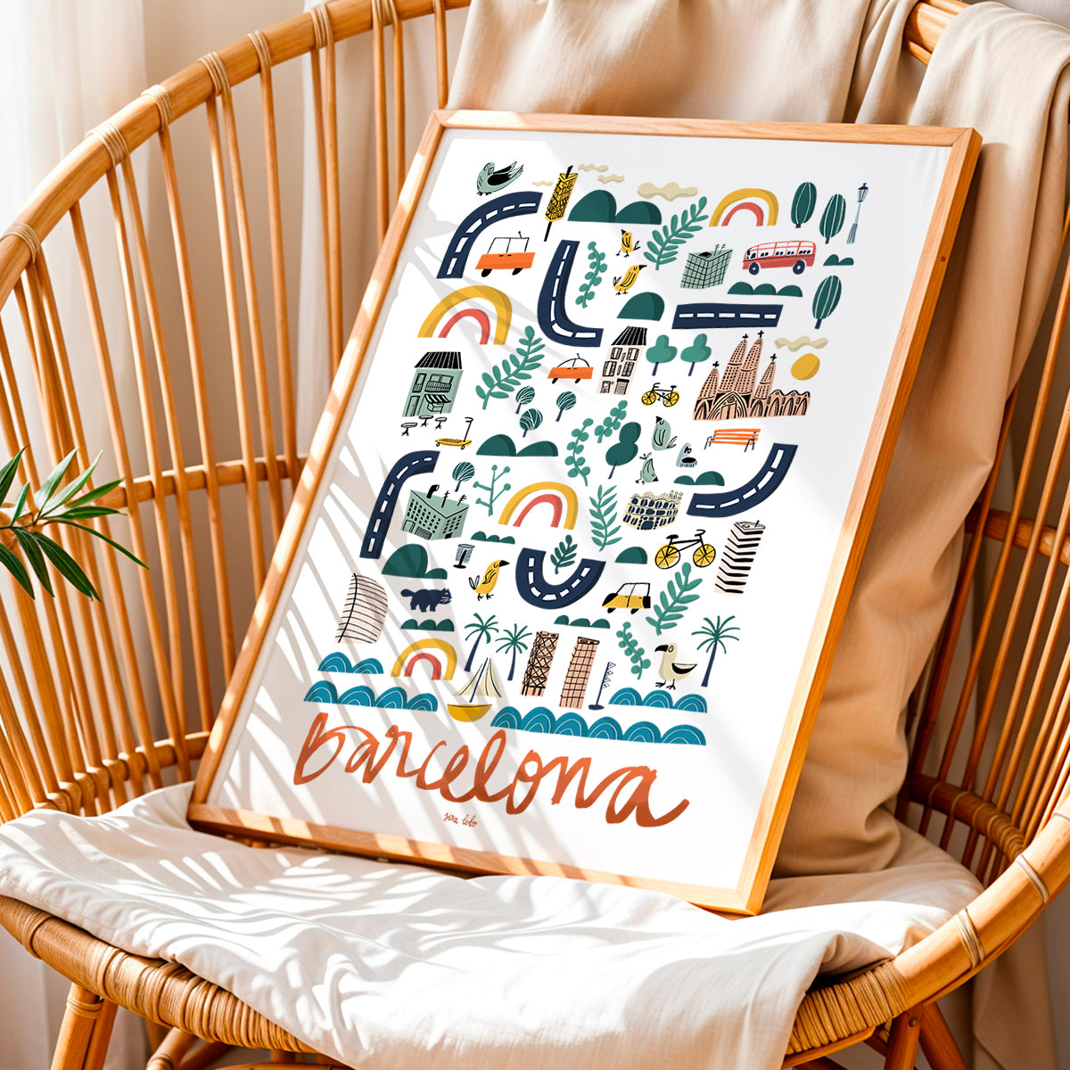 Framed artwork with 'Barcelona' design on a wicker chair