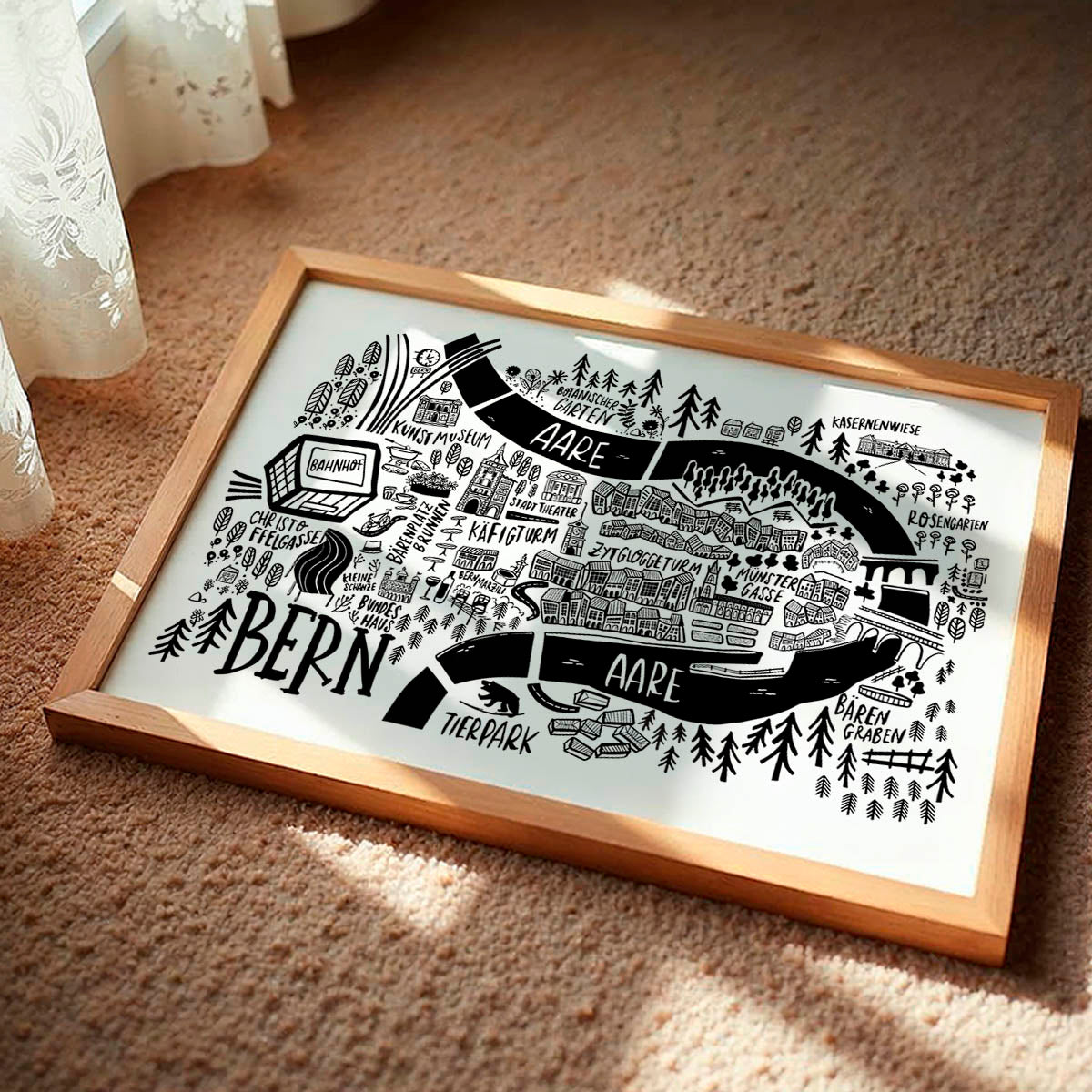 Framed black and white map of Bern on a beige carpet