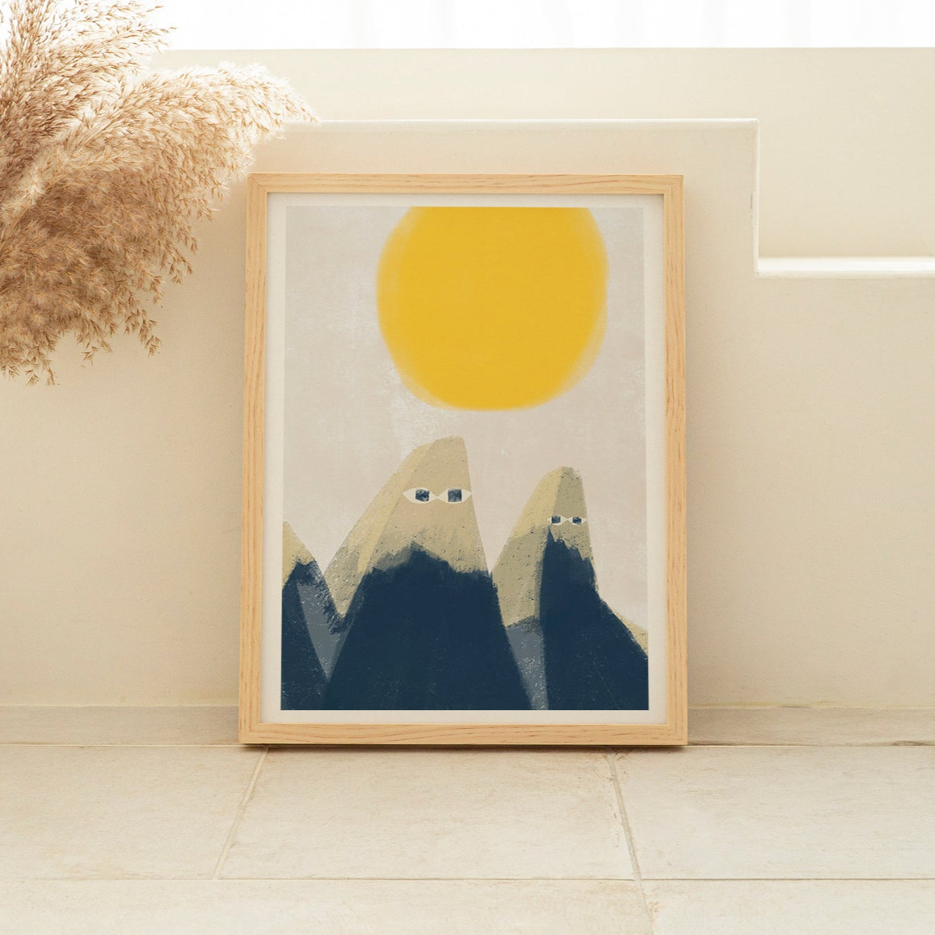 Framed artwork with mountains and a yellow sun in a minimalistic room.