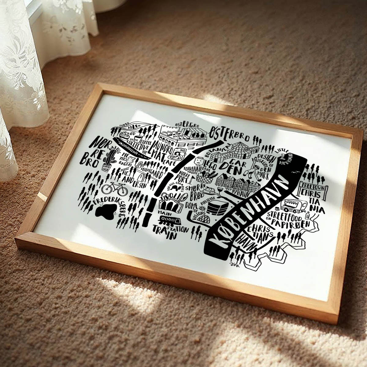 Framed black and white map of Copenhagen on a beige carpet
