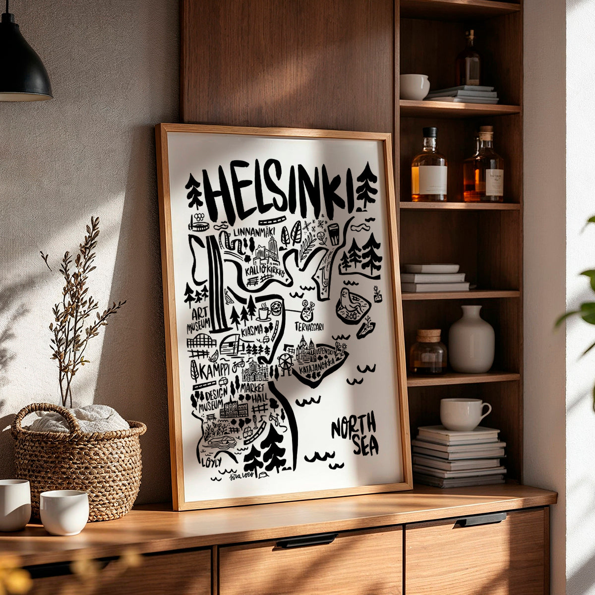 Framed map of Helsinki on a wooden shelf with decorative items.
