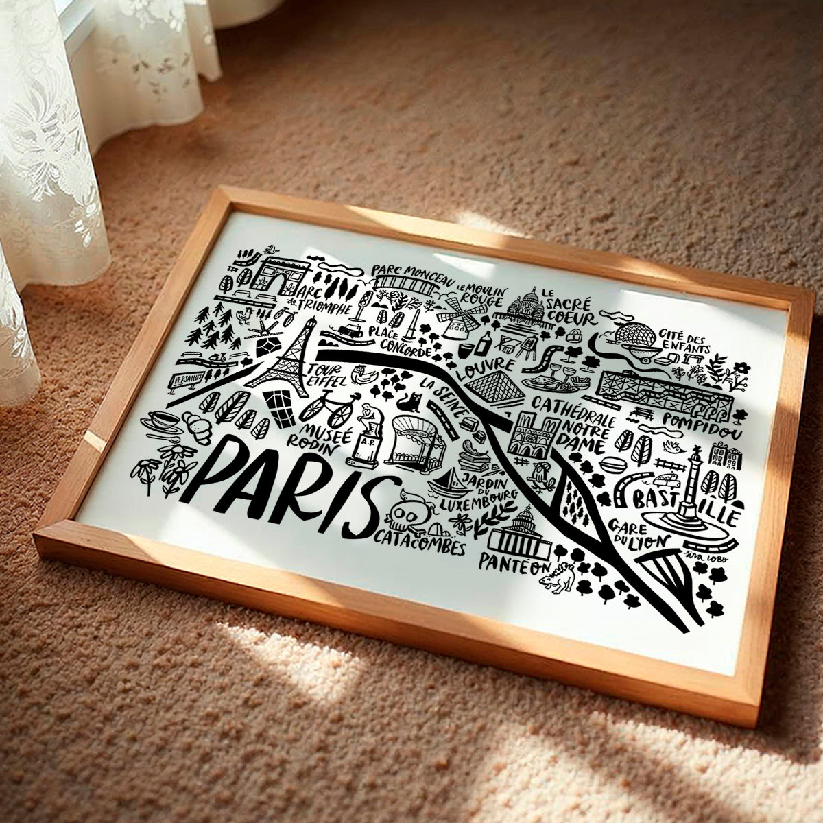 Framed map of Paris with landmarks on a textured surface