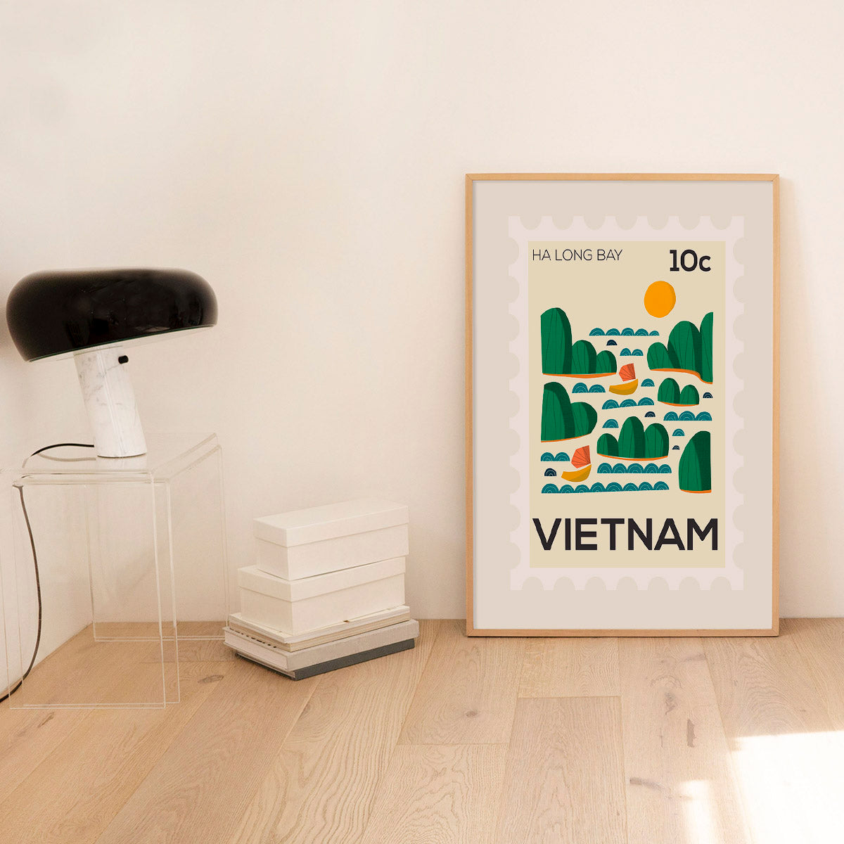 Framed poster of Ha Long Bay, Vietnam on a wall with minimal decor.
