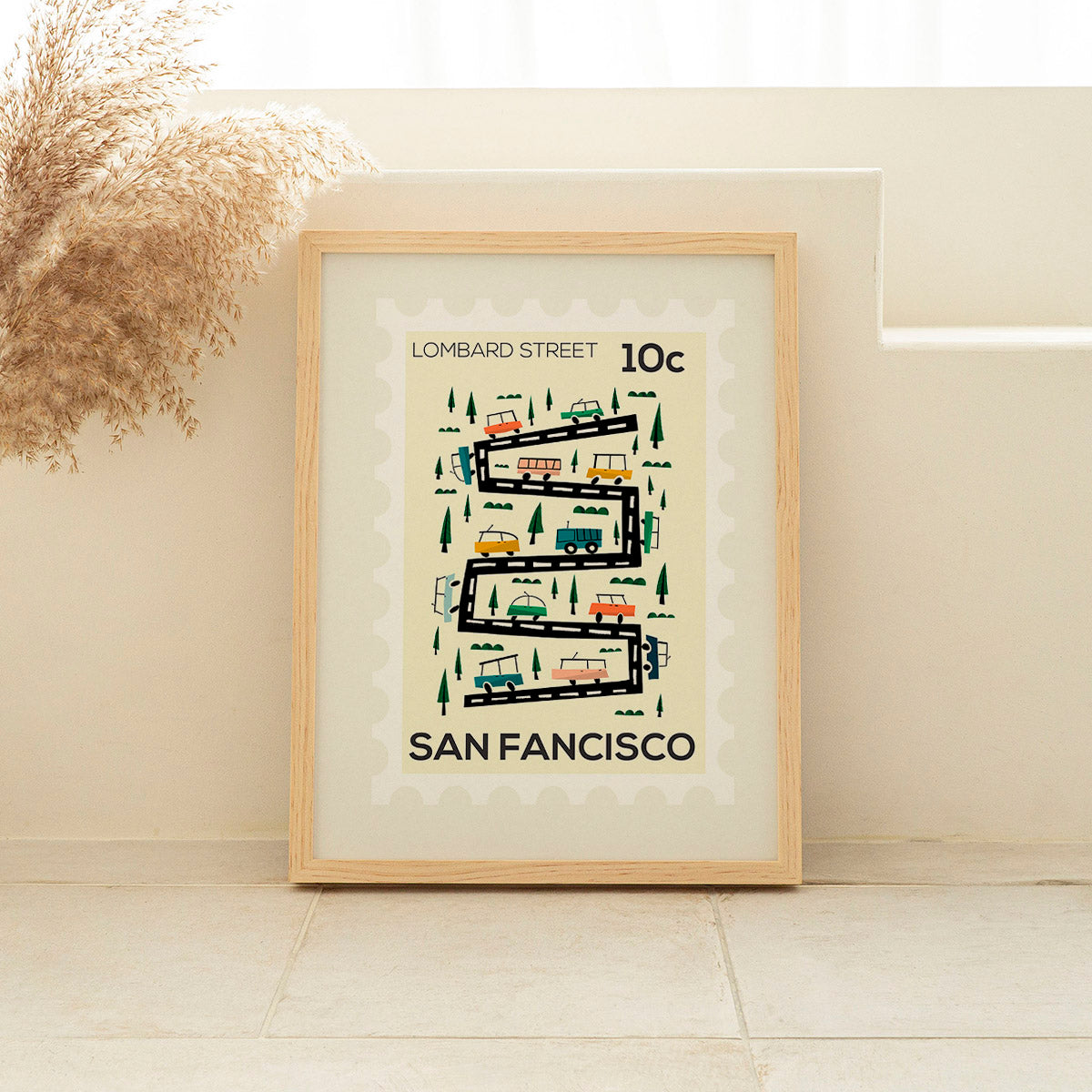 Framed poster of Lombard Street in San Francisco on a beige wall.