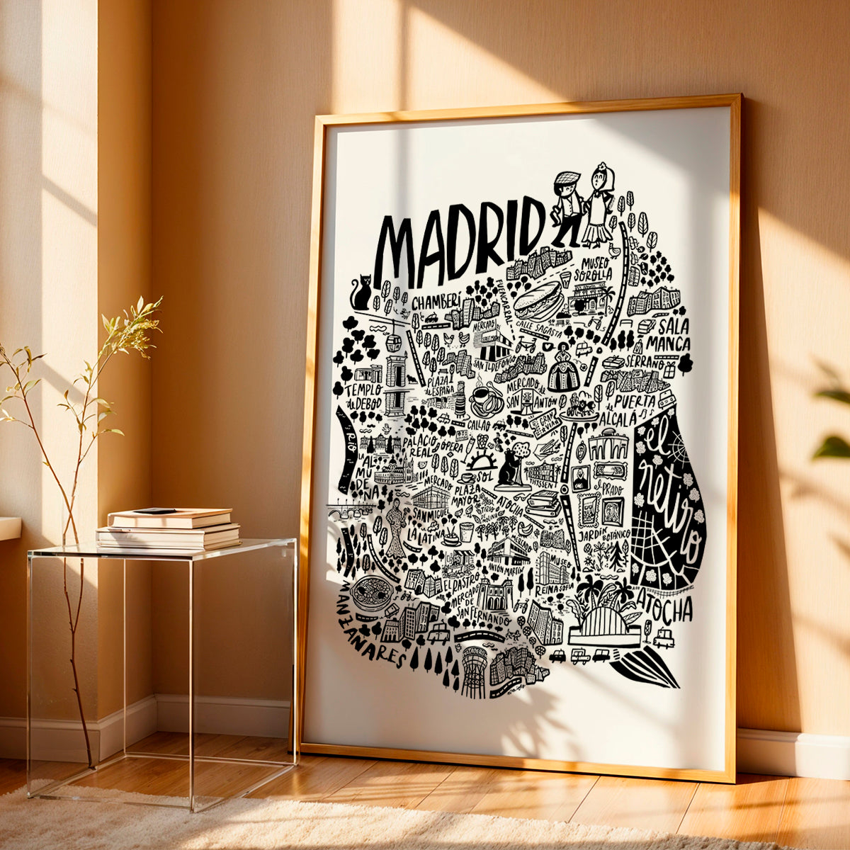 Framed map of Madrid on a wall in a room with sunlight