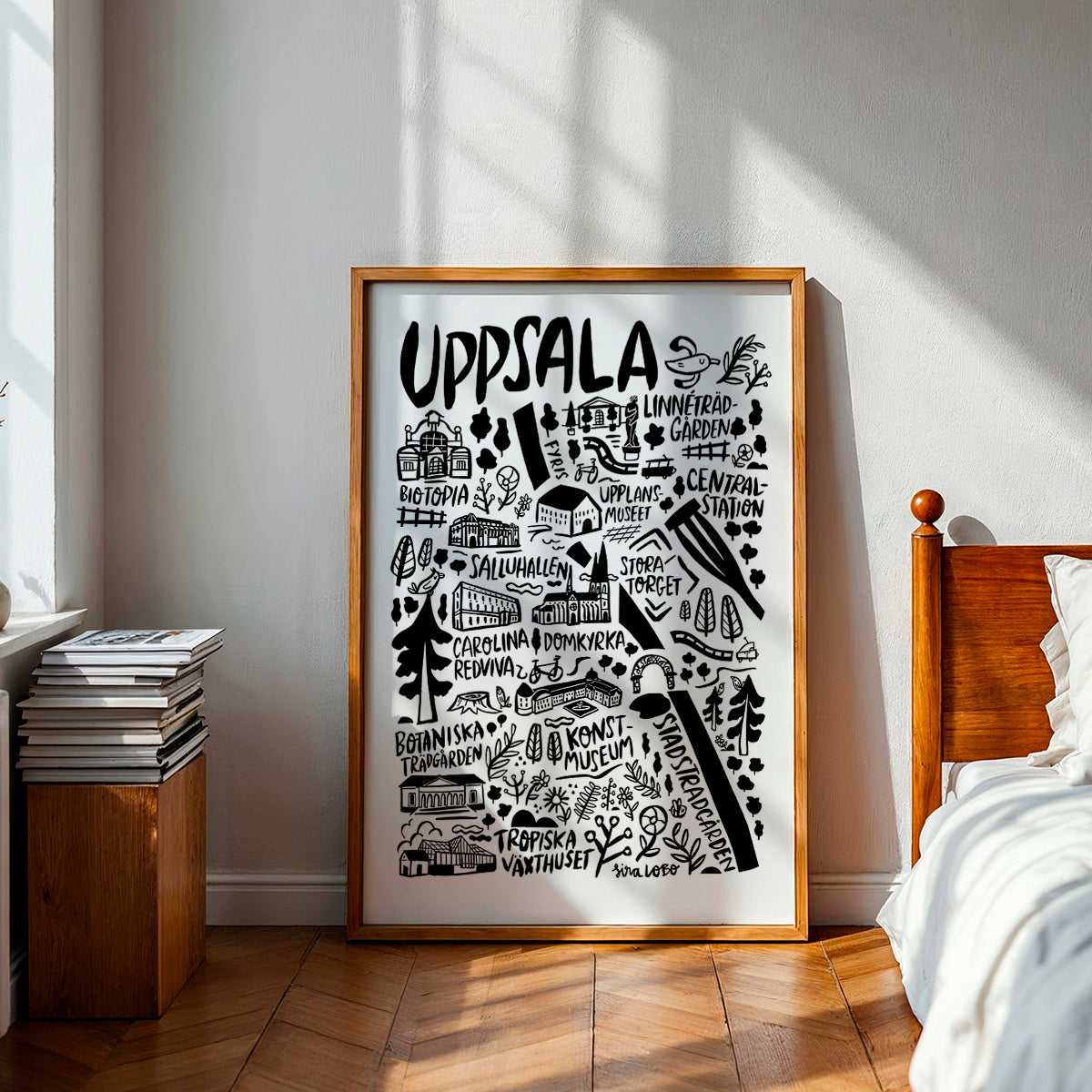 Framed poster with 'Uppsala' design in a bedroom setting