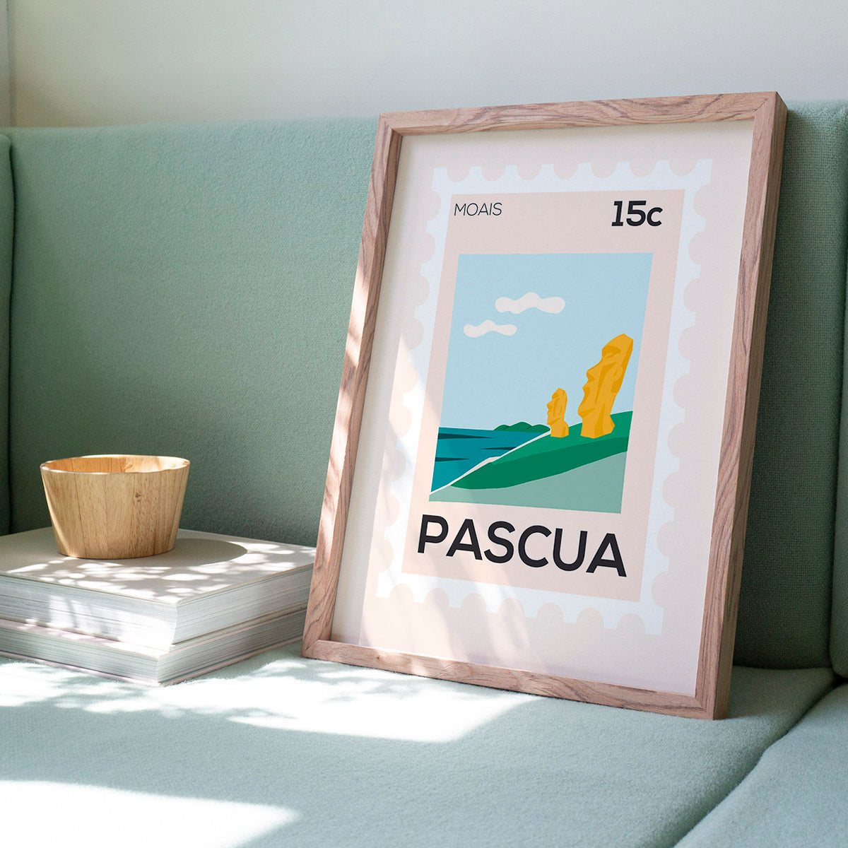 Framed artwork with 'Pascua' text on a light green couch