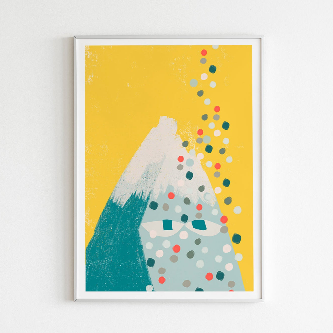 Framed artwork with a mountain and colorful dots on a yellow background