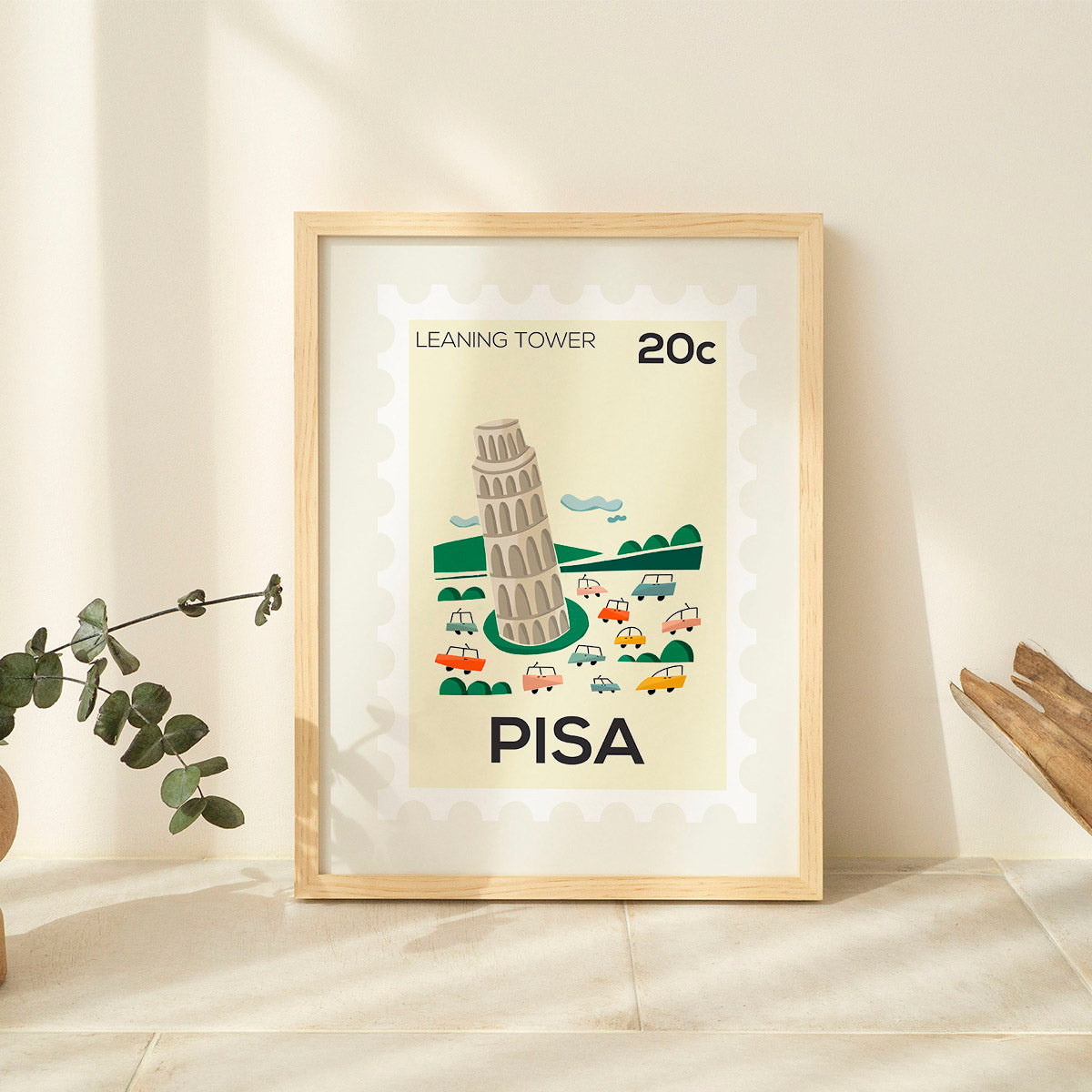 Framed poster of the Leaning Tower of Pisa with cars on a beige background