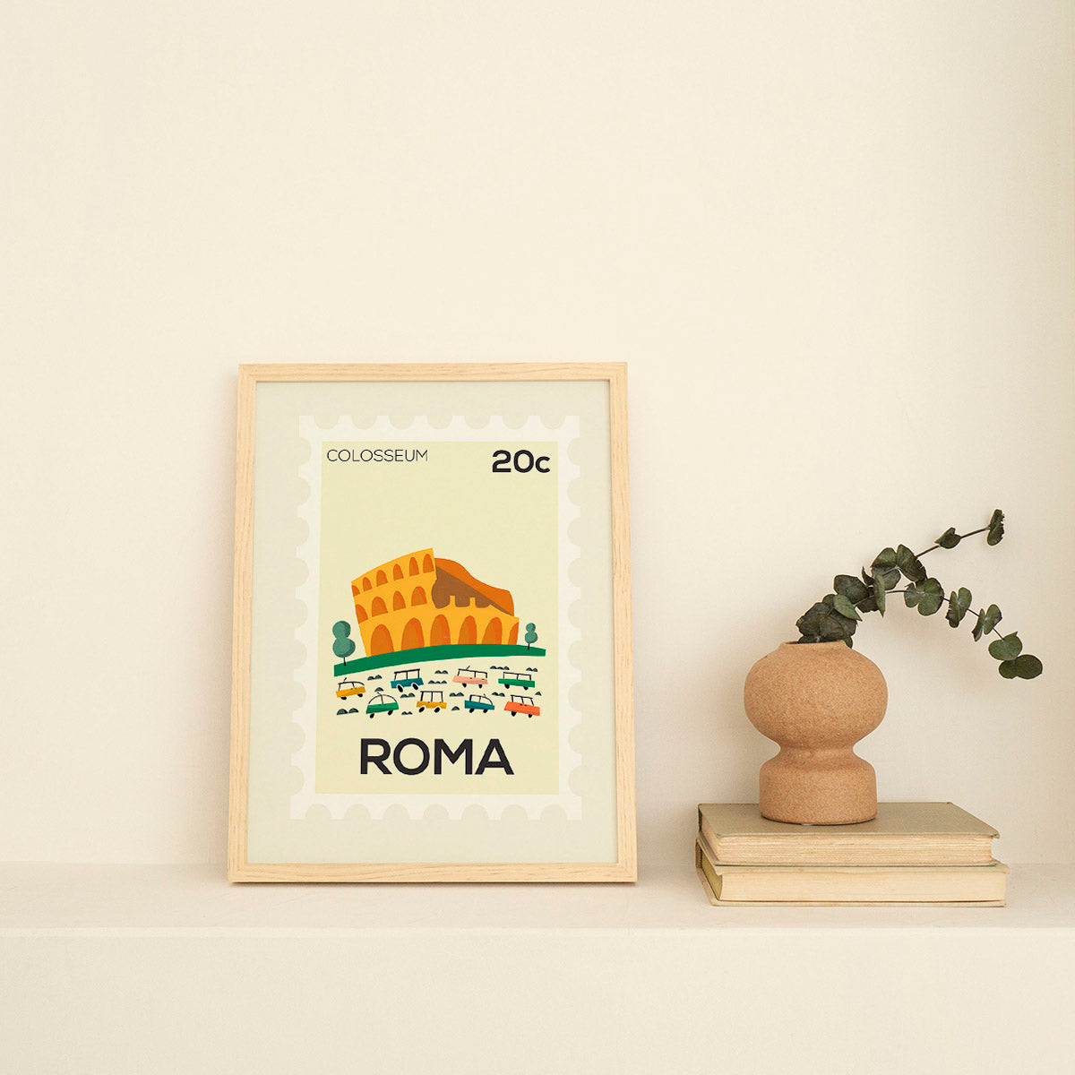 Framed artwork of the Colosseum with 'Roma' text on a beige wall.