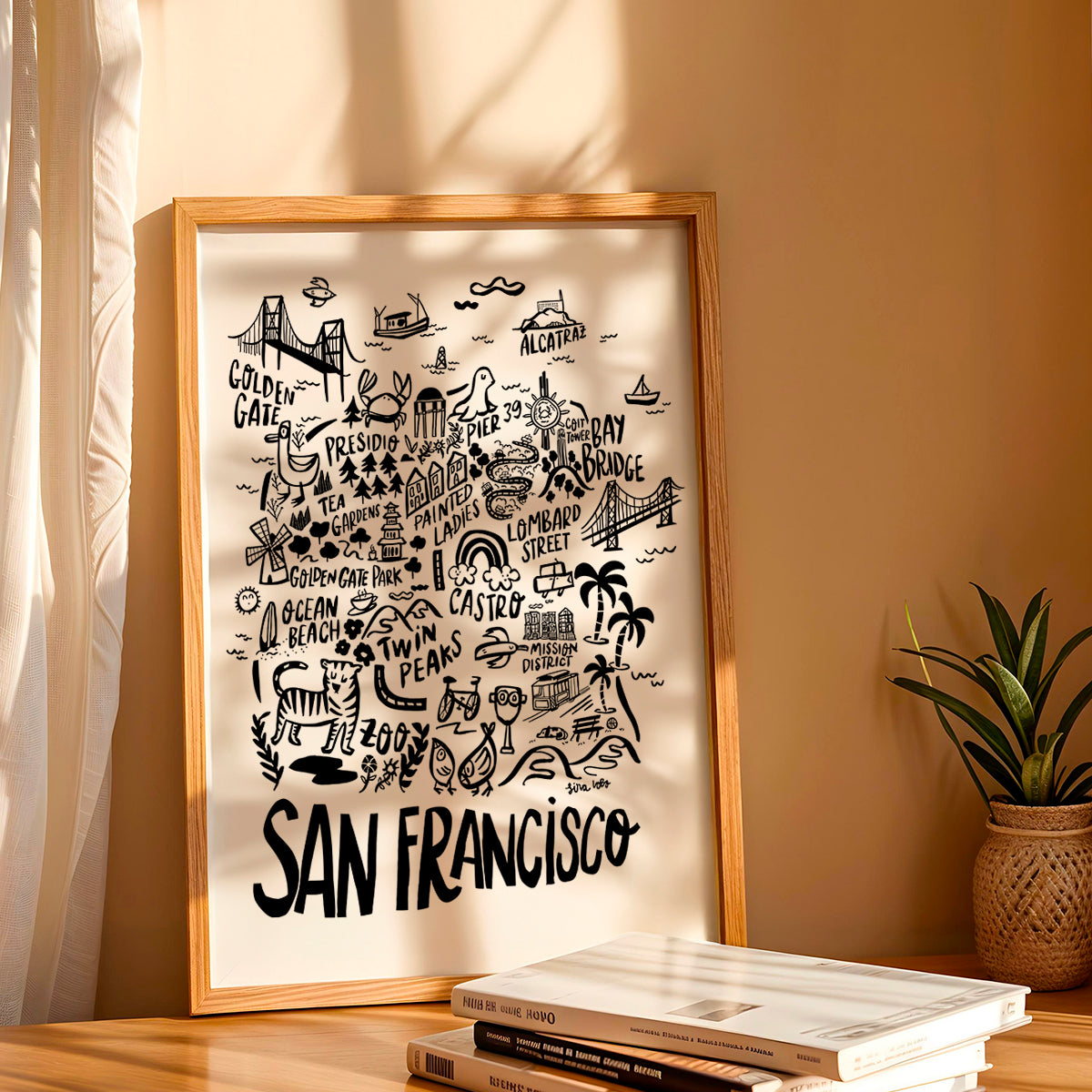Framed map of San Francisco on a wall with books and a plant below