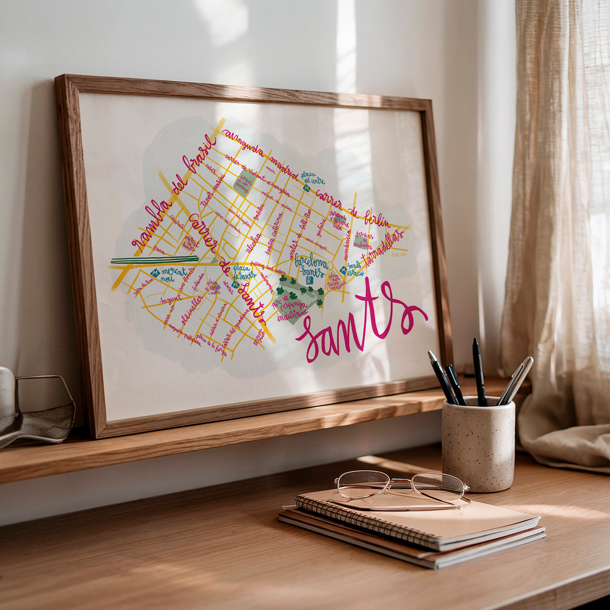Framed map of Sants in Barcelona on a shelf with stationery items