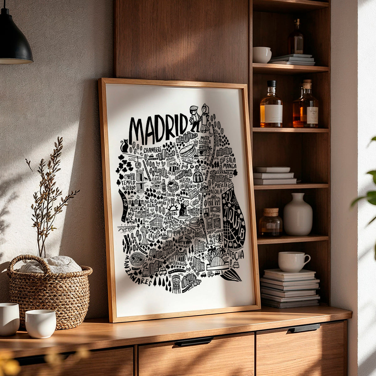 Framed map of Madrid on a wooden shelf with decorative items.