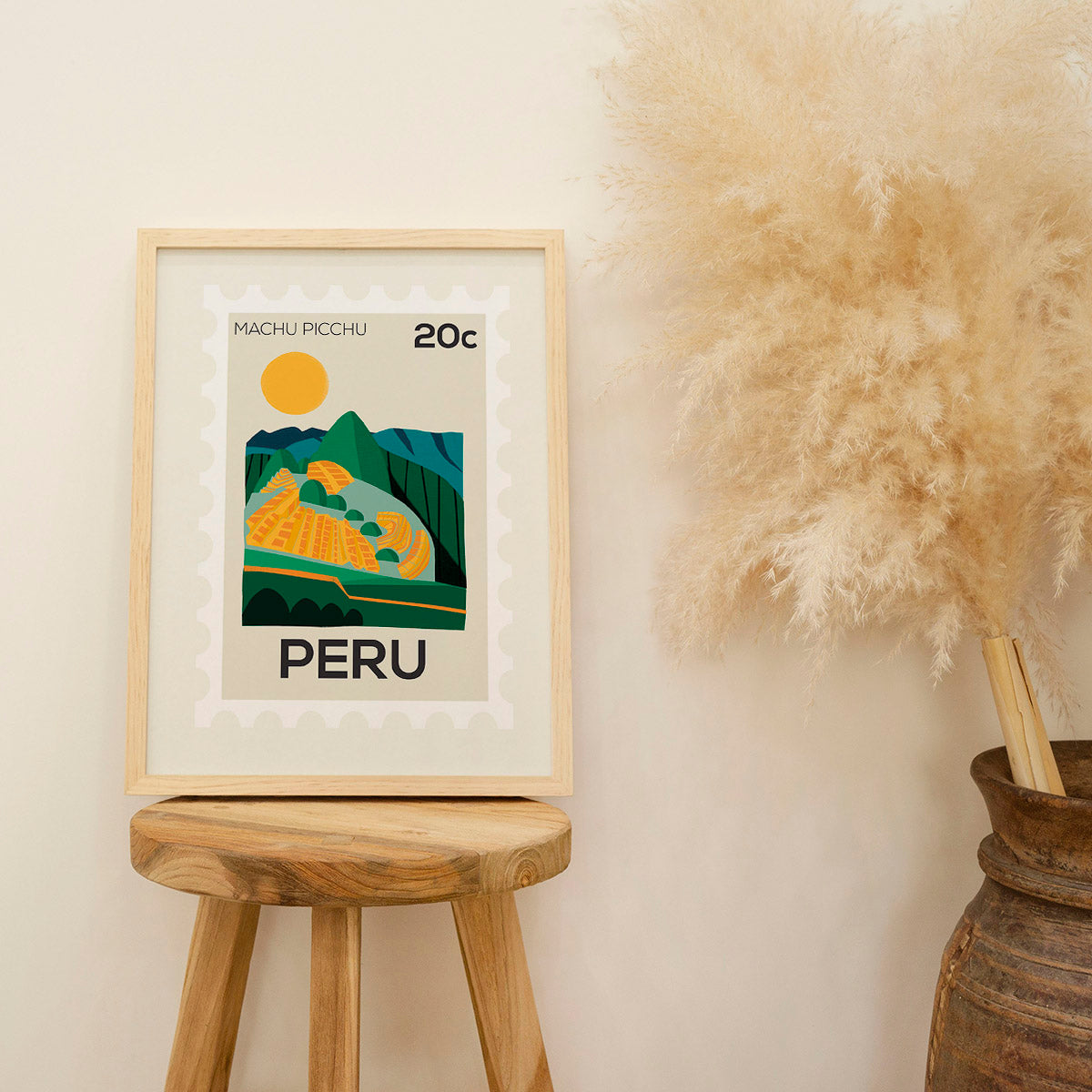 Framed artwork of Machu Picchu on a wooden stool with decorative elements.
