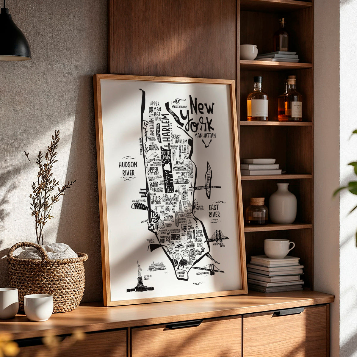 Framed map of New York City on a wooden shelf with decorative items.