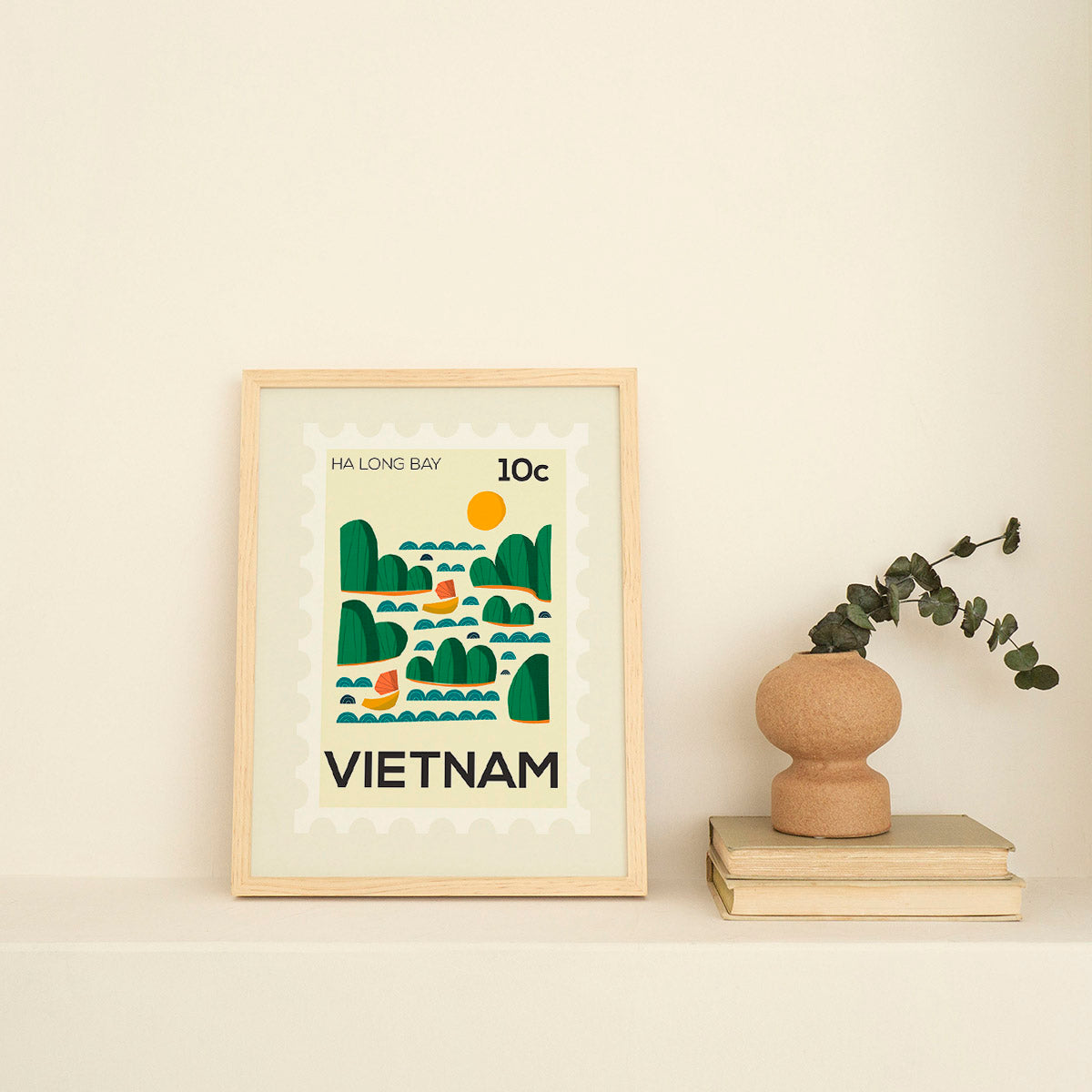 Framed artwork of Vietnam with a vase and books on a light background
