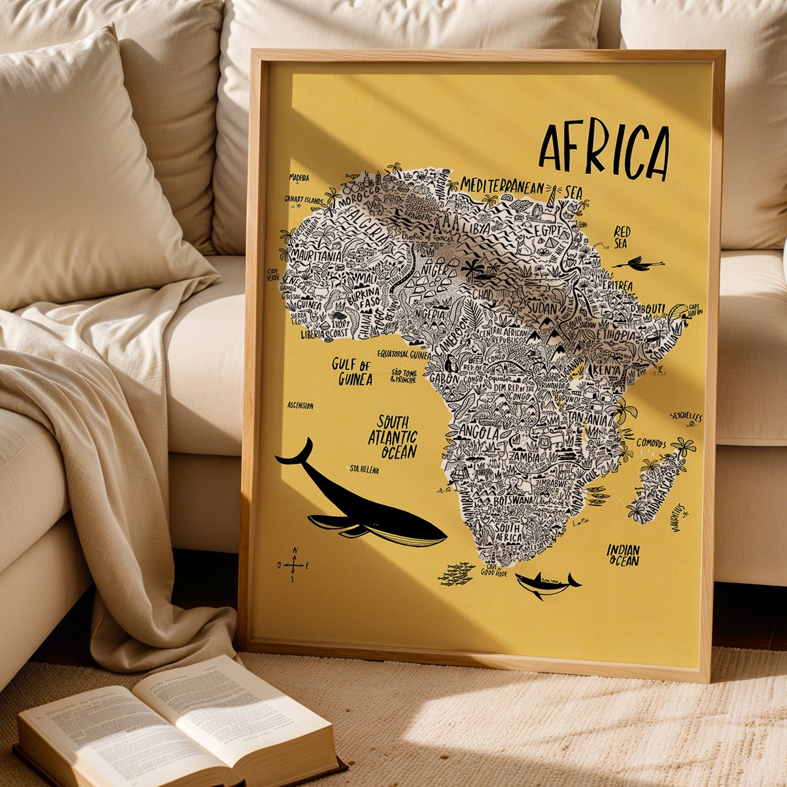 Framed map of Africa on a yellow background in a living room setting.