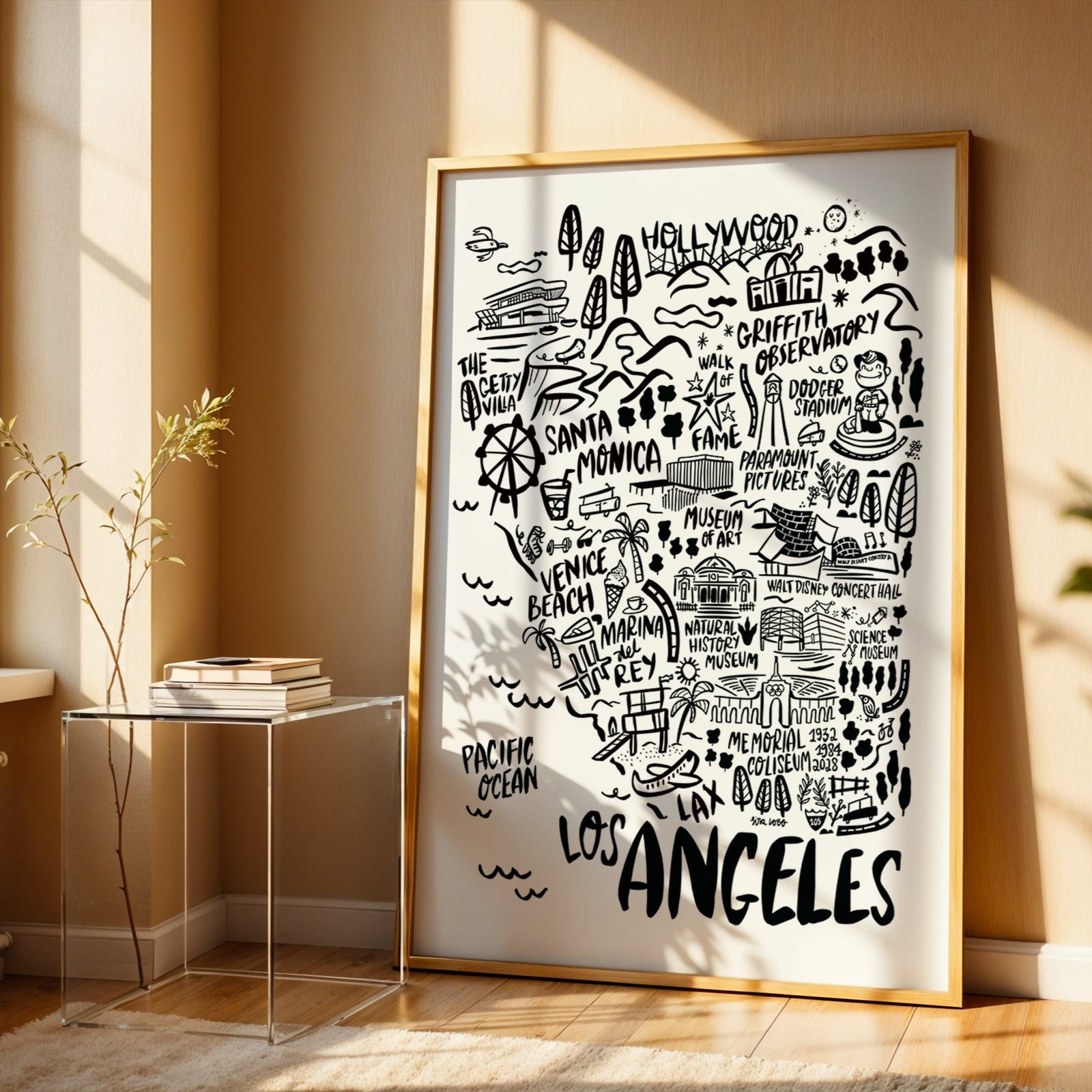 Framed map of Los Angeles in a room with a window and side table.
