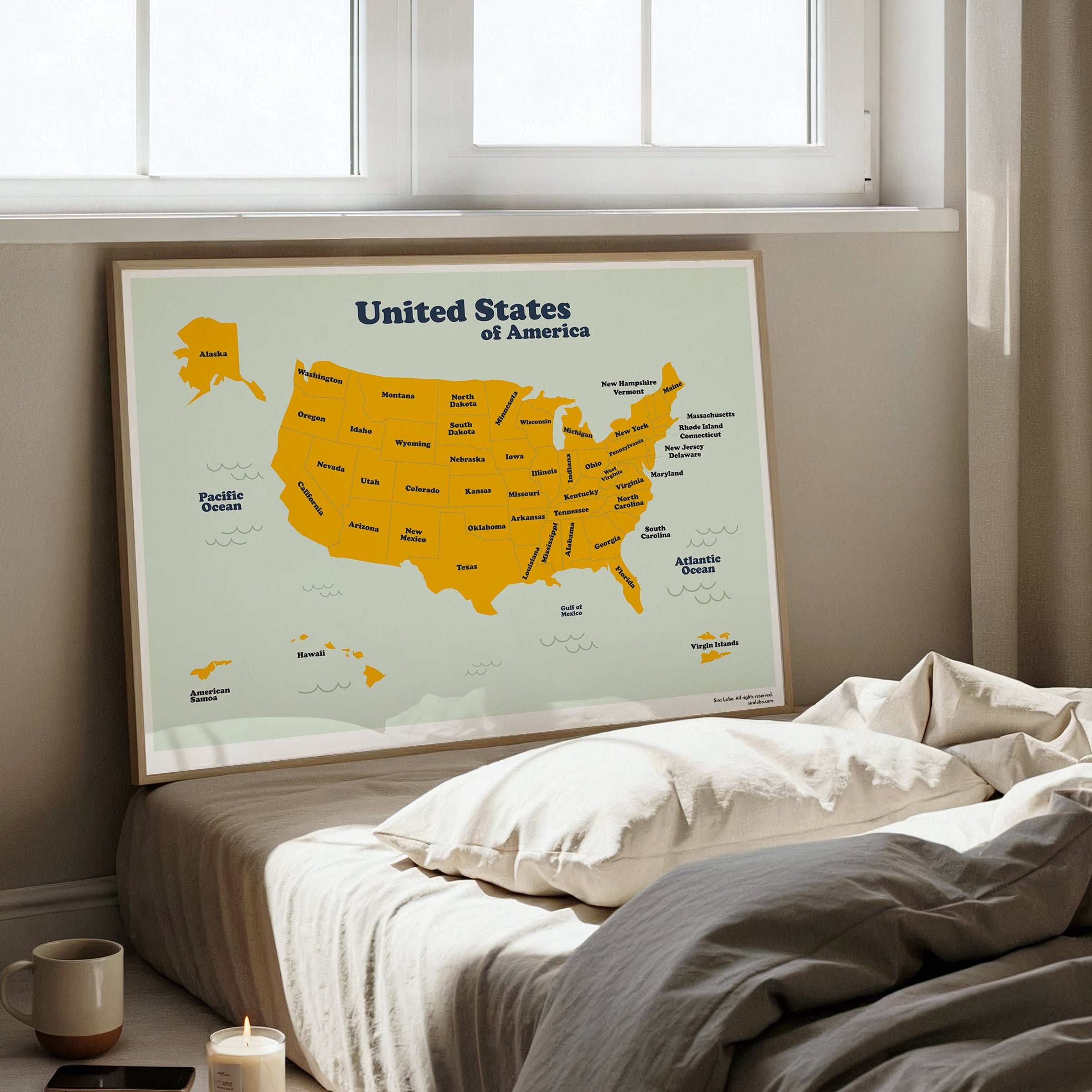 Map of the United States on a wall above a bed in a bright room
