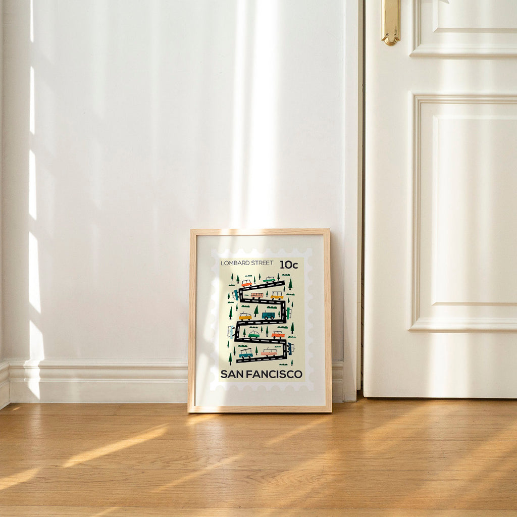 Framed artwork of a map of San Francisco on a wall with sunlight filtering through curtains.