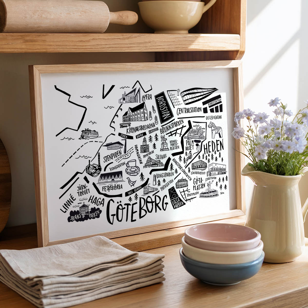Framed map of Gothenburg on a wooden shelf with kitchen items.
