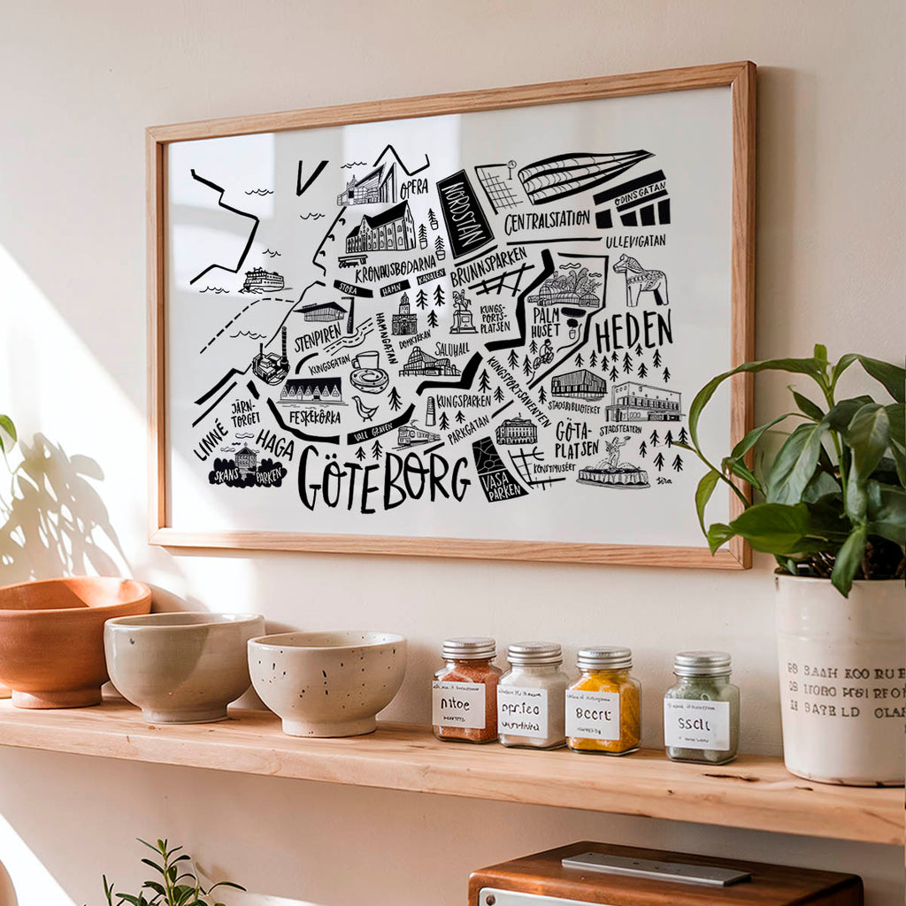 Framed map of Gothenburg on a wall above a shelf with decorative items.