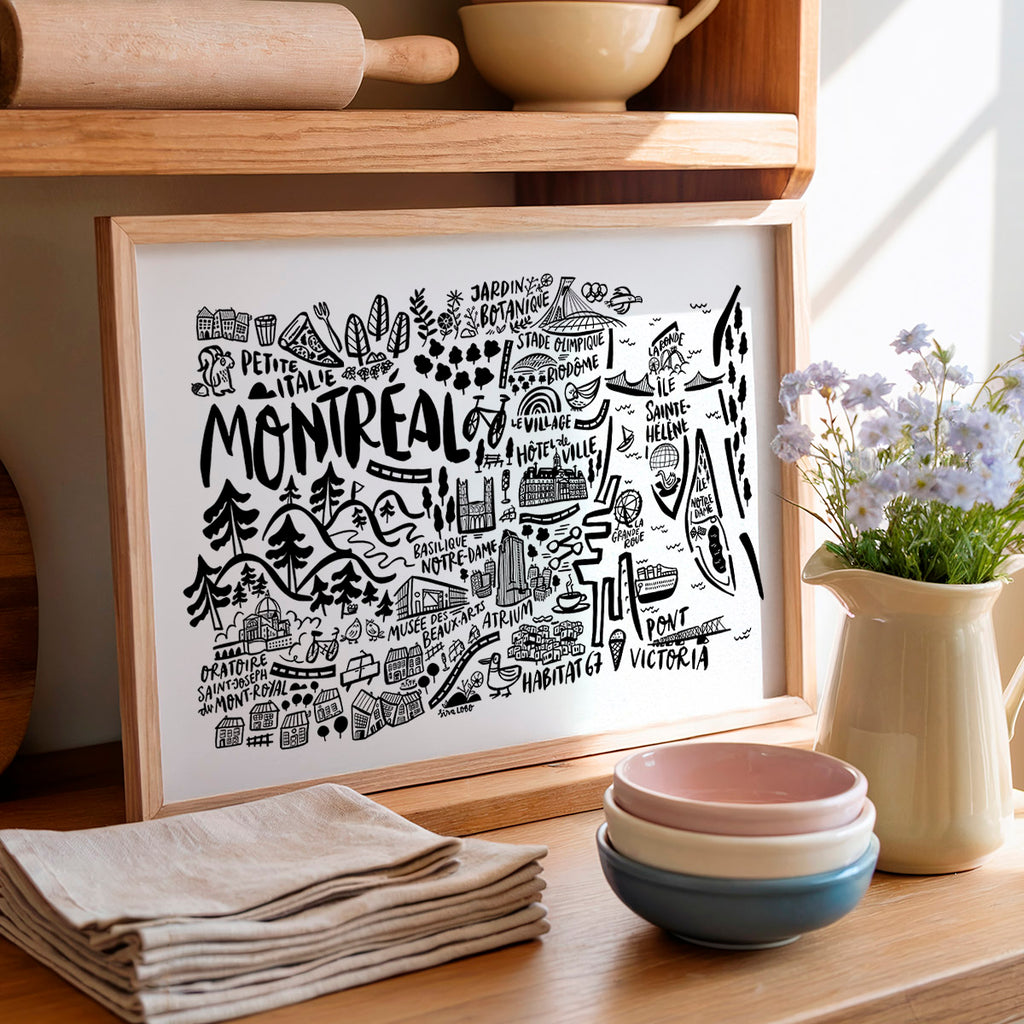 Framed artwork with 'Montreal' design on a wooden shelf with kitchen items.