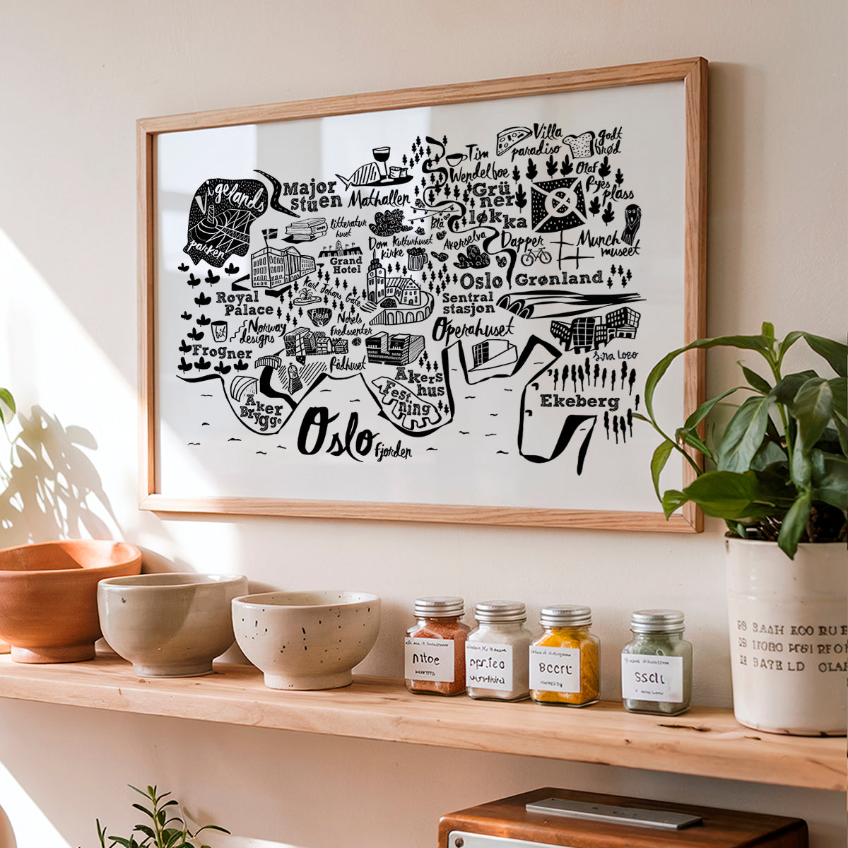 Framed map of Oslo on a wall above a shelf with decorative items.