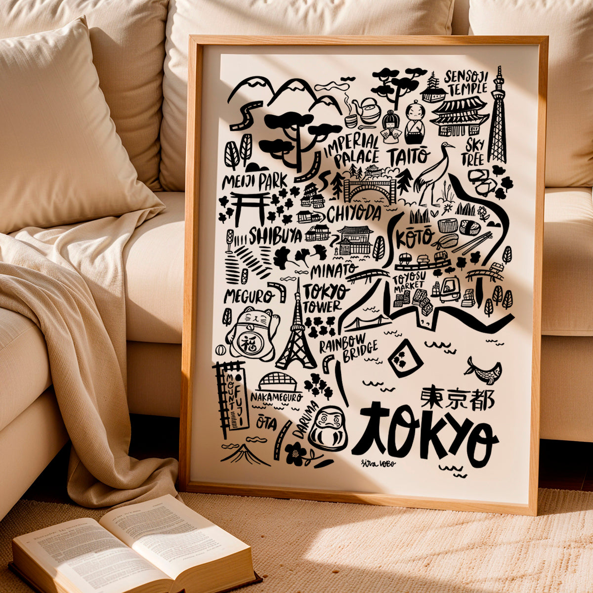 Framed map of Tokyo with landmarks on a beige couch background