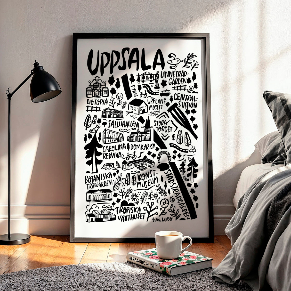 Framed artwork with 'Uppsala' and various landmarks in a bedroom setting.